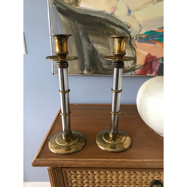 This is a pair of tall and heavy brass and chrome. Bamboo motif , candlesticks made by Maitland Smith probably from 1980