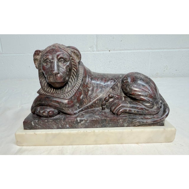 This antique hand carved 19th century reclining lion statue is an absolutely stunning sculpture crafted from solid marble....