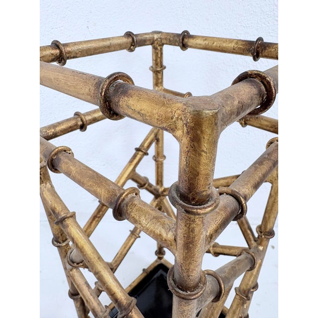 This is a mid 20th century vintage Gilded wrought iron faux bamboo umbrella stand. This umbrella stand was American made...