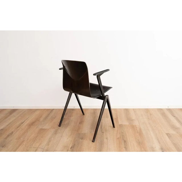 Model S22 industrial chair with armrests by Galvanitas. The chair comes with a dark brown wooden seating and a dark brown...
