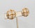 1960s round goldtone "checkered" earrings with groups of four round clear rhinestones with rhodium plated surround clip...
