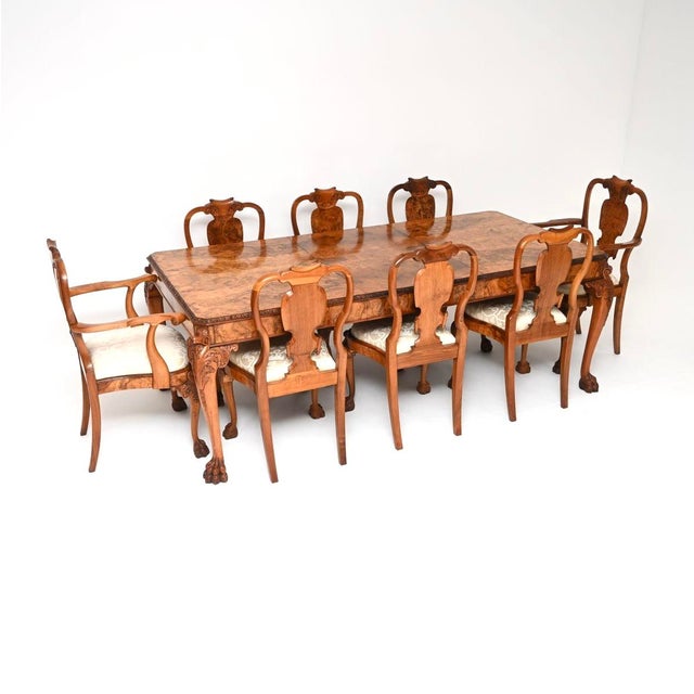 An exceptional antique burr walnut Queen Anne style dining table and eight chairs. This was made in England, it dates from...