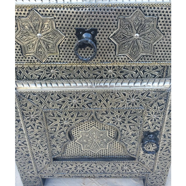Very exotic all metal inlaid Moroccan nightstand. With its detailed carving, measuring approximately 24" in height, 19" in...