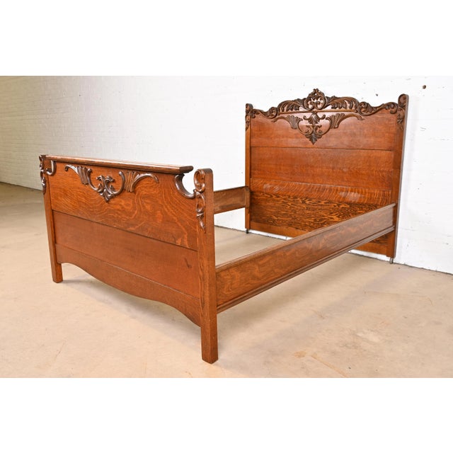 A gorgeous antique Victorian carved oak full size bed frame USA, Circa 1890s Measures: 56.5"W x 77"D. Headboard: 50.5"H....