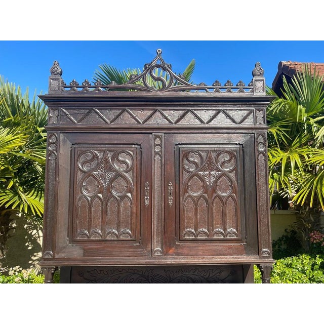 Gothic-style sideboard in richly carved wood. It opens with two doors at the top and, at the bottom, two drawers and two...