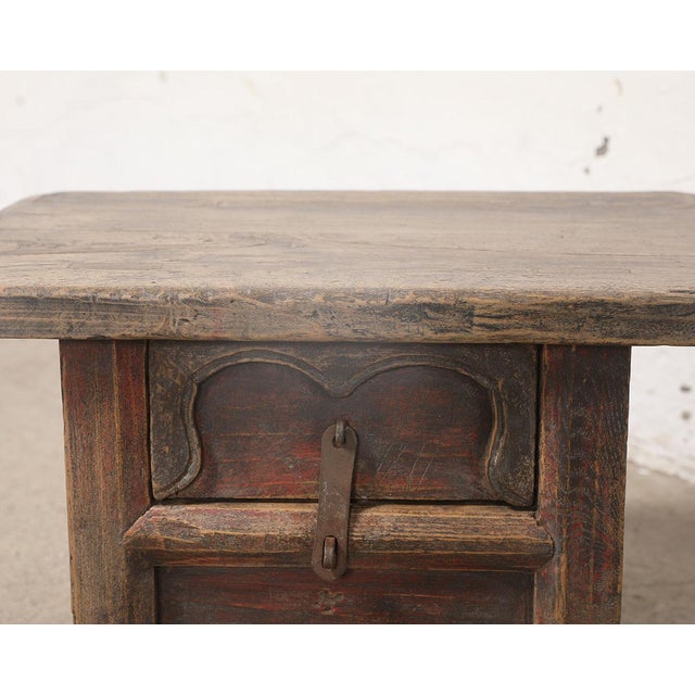 A charming vintage Chinese small cabinet crafted from solid elmwood, dating to the first half of the 20th century. The...