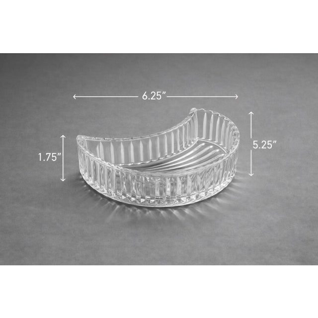 A striking pair of vintage ribbed crescent crystal dishes inspired by classic Art Deco design. Their sculptural curved...