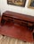An impressive antique mahogany butler's desk featuring a distinctive curved cylinder front, an extensively fitted writing...