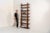 Sculptural wengé slat bookcase (Europe, 1960s). A sculptural bookcase defined by the rhythmic interplay of solid wengé...