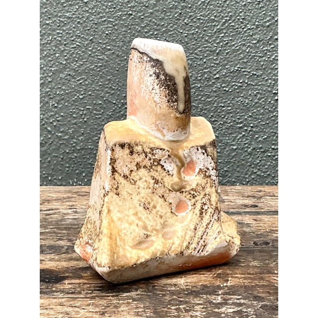Crafted from ceramic, this vintage abstract vase presents an intriguing play of form and texture with a compact,...