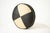 Aesthetic: A bold graphic accent, this round throw pillow features a striking pinwheel of black and creamy white leather...