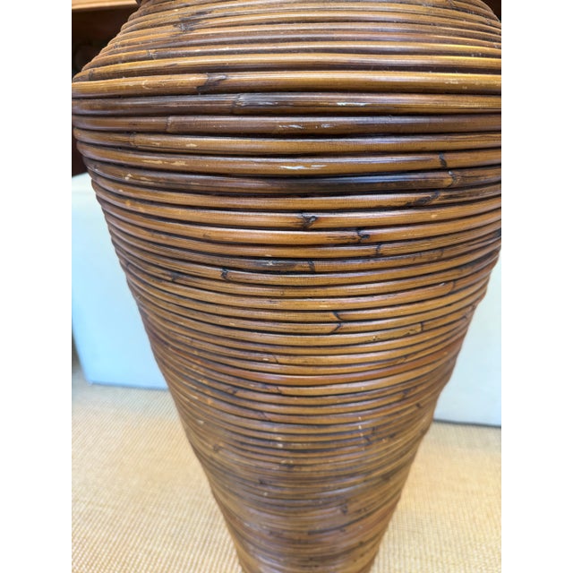 Wonderfully large coastal pencil reed rattan floor vase. Would be amazing with fresh tropical leaves or can be used as a...