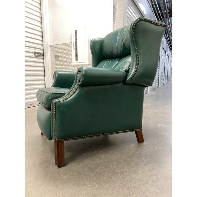 Fine Chippendale style reclining wingback chair model 4114 in teal patent leather with, french brass nailhead trim, in...