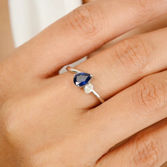 Dainty Blue Sapphire Diamond Bridal Ring in 14K Gold featuring natural blue sapphire of 0.58 carats and diamonds of 0.11...