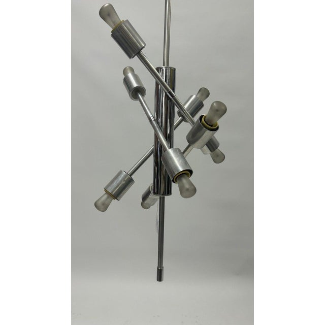 Chromed metal structure consisting of a central supporting body, 8 arms and 8 exposed light bulb sockets. I have official...