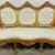 This elegant French Rococo sofa features pristine white leather upholstery paired with a fully refinished gold leaf frame,...