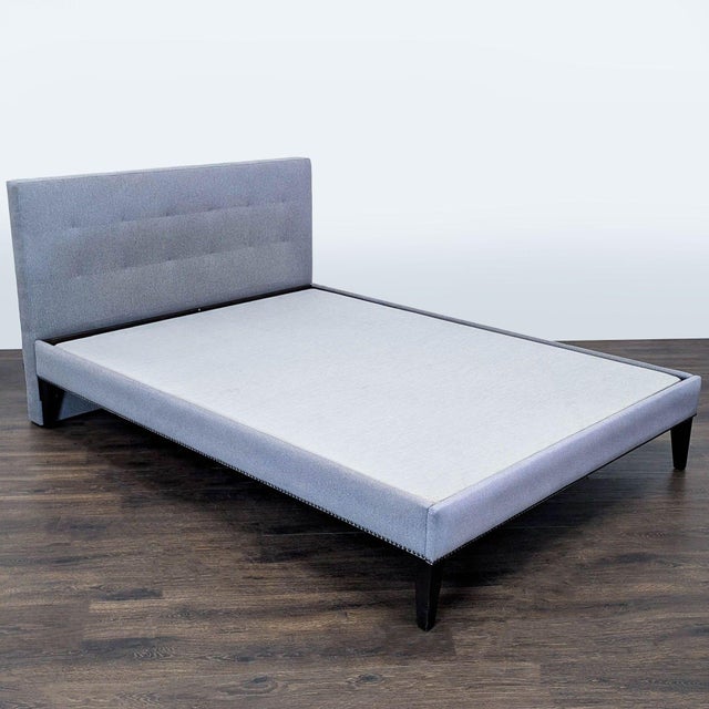 Upgrade your bedroom with this West Elm Queen bed frame. It features a sleek grey upholstered design with a tufted...