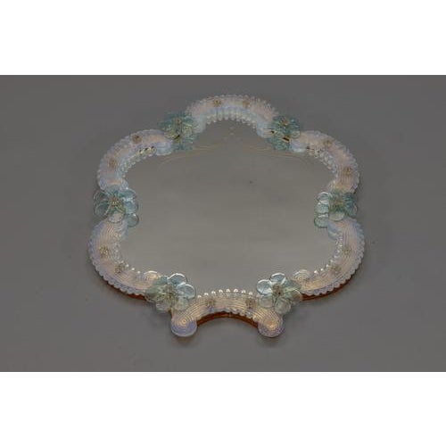 Delicate 1950s Murano glass wall mirror with delicate light blue floral details and opalescent beaded frame. A graceful...