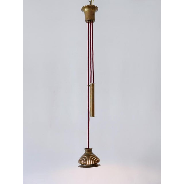 Extremely rare, lovely and highly decorative mid-century modern perforated brass pendant lamp. Designed & manufactured...