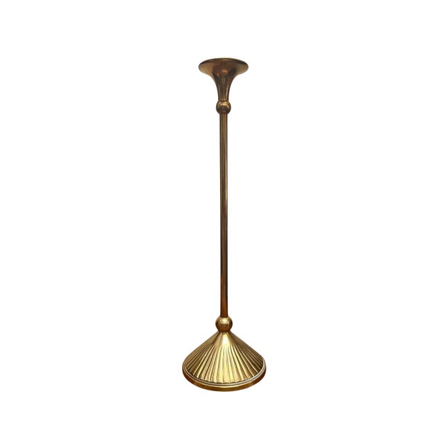 A refined vintage solid brass candlestick featuring an elegant, elongated silhouette and beautifully fluted detailing. The...