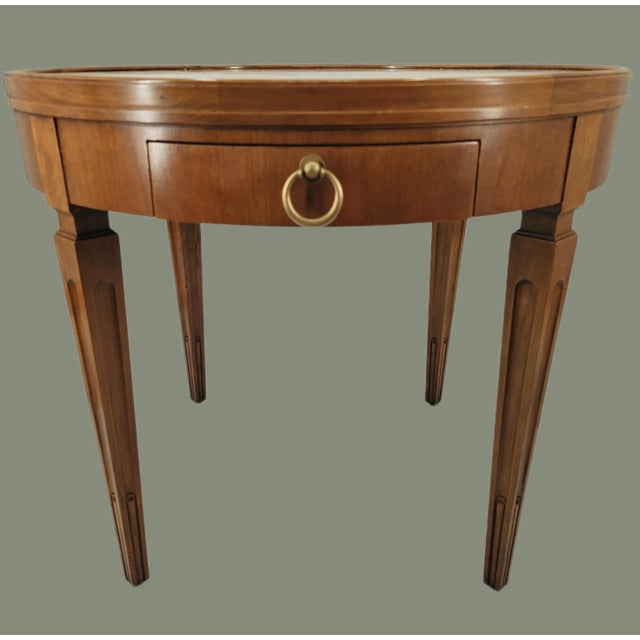 Featured is a Hollywood Regency style Vintage Baker Walnut Round Sunburst Gallery Top Drawer Side Table. Single contoured...