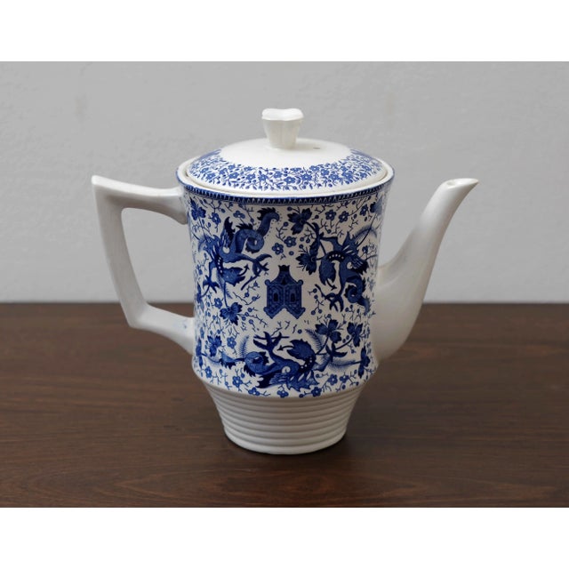 Elegant porcelain tea or coffee pot produced by the Belgian manufacturer Boch Frères La Louvière, decorated with a...