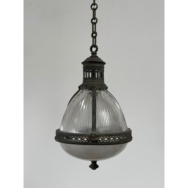 - a wonderful and rare teardrop caged holophane pendant with original chain and ceiling rose, france circa 1920. - the...