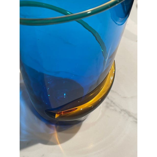 A striking vintage Blenko Handcraft art glass vase in saturated cobalt blue, featuring a sculptural baluster form accented...