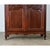 A French solid oak armoire from the 19th Century, crafted in the Louis XV style with carved floral motifs. Below the...