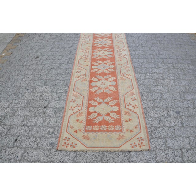 This is a vintage Turkish Oushak rug from the 1960s. The piece was hand-knotted.