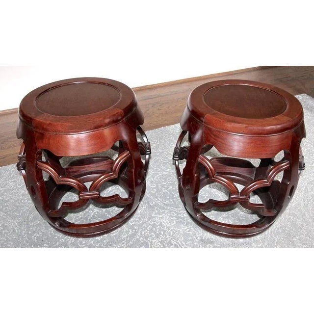 Pair of Chinese nicely carved hardwood garden stools. Each with carved and pierced decoration to the four supports and bases.