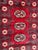 Vintage Bokhara design Pakistani rug with a red field colour and white, gray and black, entirely hand knotted with wool on...