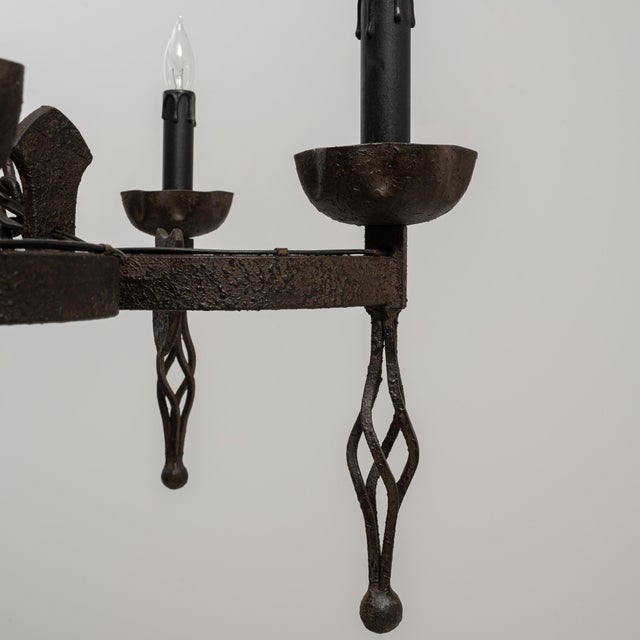 This 20th Century French Gothic Revival wrought iron chandelier showcases the dramatic, architectural presence...