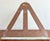 This vintage folding bookstand or easel, with its triangular cutout design and warm brown patina, blends functional...