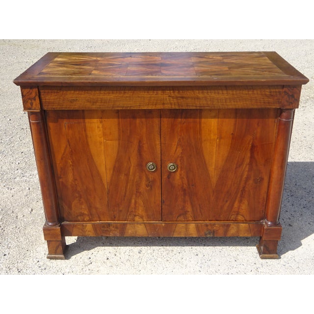 A 19th-century buffet with two doors and one drawer, featuring a curved top. Magnificent marquetry top with chevron and...