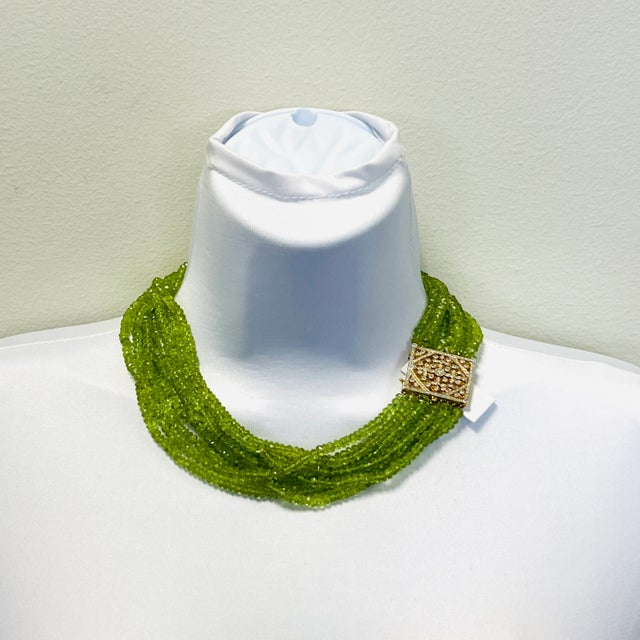 Gorgeous bright green peridot beads with a handmade 14k yellow gold diamond clasp. Length is 17".
