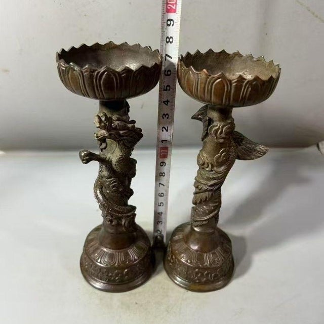 This striking pair of bronze candlesticks features a traditional dragon and phoenix motif, symbols of harmony and balance....