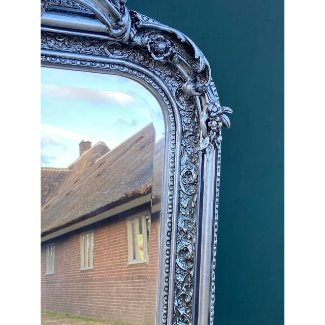 An elegant 1960s French Louis XVI–style full-length mirror, handcrafted with a richly carved wood frame and finished in a...