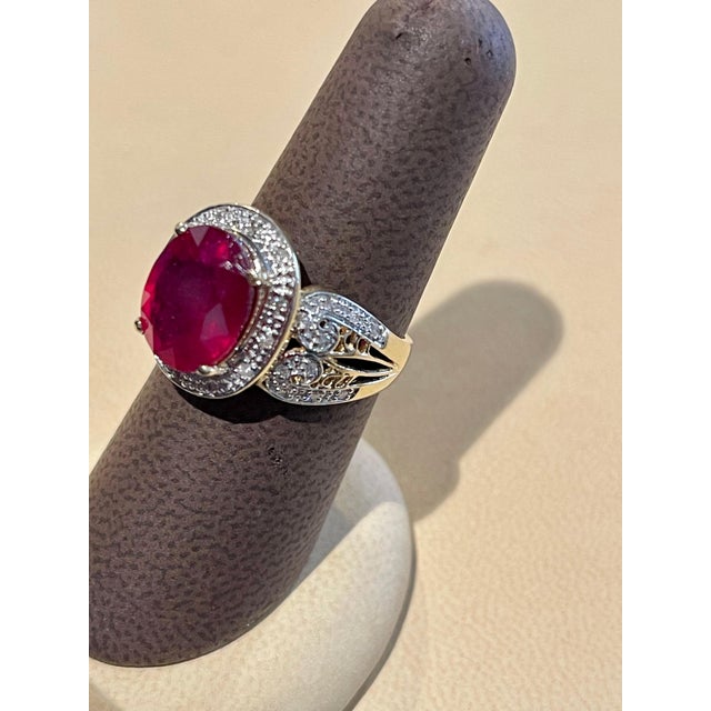 12x10 Oval Cut Approximately 7.5 Carat Treated Ruby 14 Karat Yellow Gold Ring Size 8 Diamond Brilliant cut approximately 1...