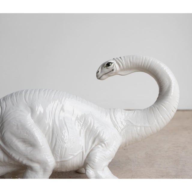LARGE MID CENTURY MAJOLICA DINOSAUR SCULPTURE A rare and extremely decorative model depicting a Brontosaurus with curved...