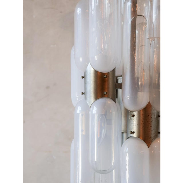 Vintage torpedo-shaped lamp with pill-shaped Murano glass shades, 1970s. This pendant lamp consists of six double groups...