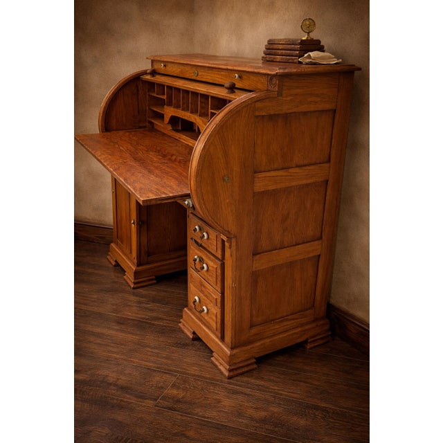 A beautifully preserved late 19th century American oak roll-top desk, showcasing classic craftsmanship, warm patinated...