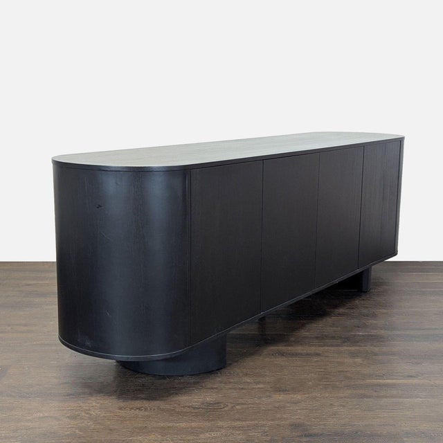 This sideboard is crafted from solid oak with natural knots and grain variation that add depth to the aged black finish....