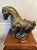This large bronze-look plaster statue in the style of a Chinese Tang Dynasty horse makes a dramatic statement. The horse...