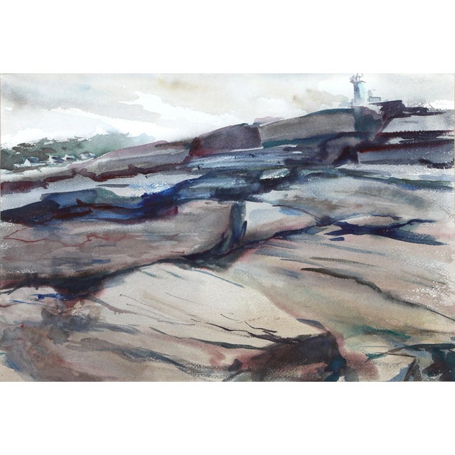 Crashing against the jetty, the white-capped waves slap over the surface of the boulders leading up to the white...