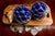 A pair of hand-blown cobalt blue glass fishing floats in original jute nets, 8 inches diameter (approx. 9" including the...
