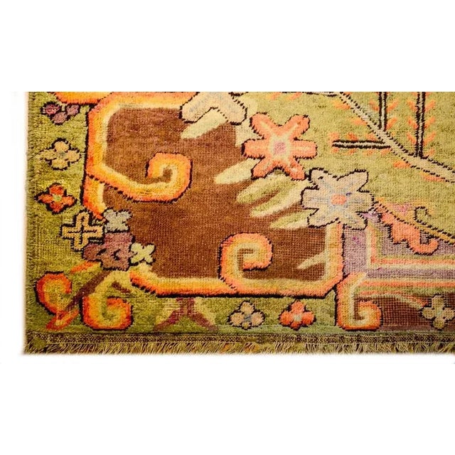 An extraordinary early 20th century Central Asian Khotan rug with an incredible asymmetrical large-scale floral medallion...