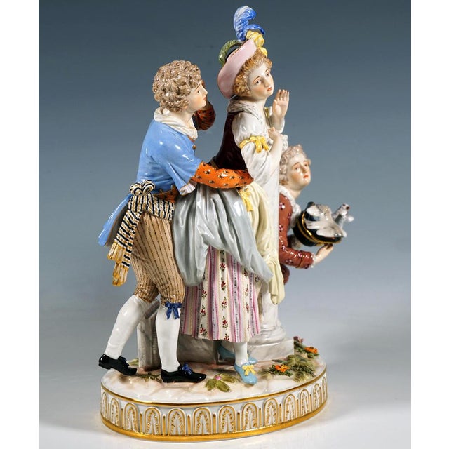 Exceptional rare meissen porcelain group: a group of three figures in elaborate rococo attire: the young, pretty lady in a...
