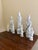A serene grouping of seven blanc de chine figures depicting Quan Yin, the bodhisattva of compassion, rendered in softly...