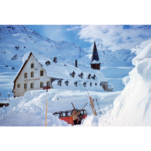 A Hotel In The Mountains by Toni Frissell Skiers and a VW ski bus in front of the Alberg Hozpis Hotel, St. Anton, Austria,...